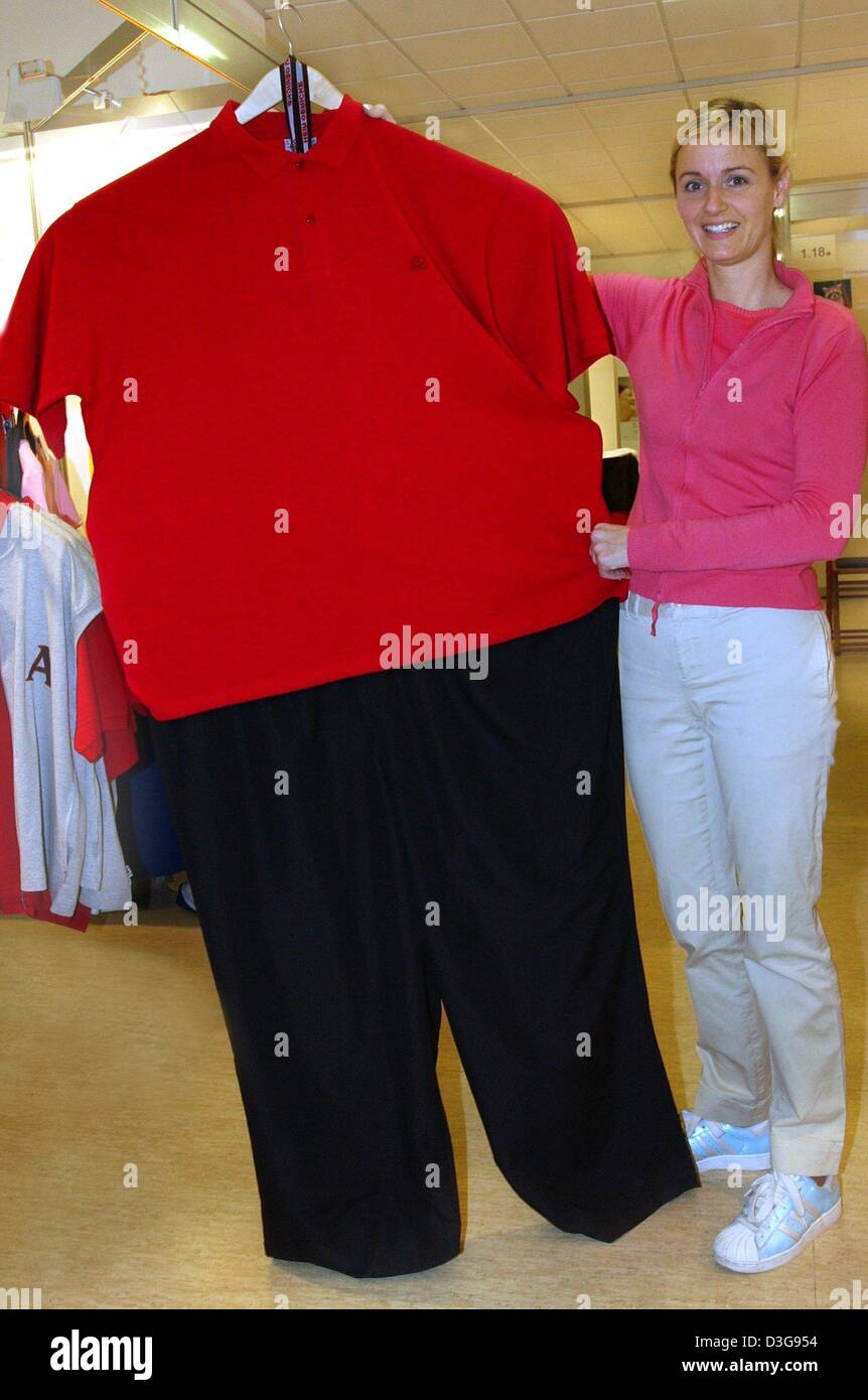 (dpa) - An employee of a sportswear company presents a pair of trousers and a shirt both of the size 10 XL which fit an abdominal girth of up to two metres at the fair 'Rundum' (all around) in Berlin, Germany, 7 November 2004. The trade fair for overweight, health and zest for life shows offerings by numerous exhibitors and offers lectures, fashion shows and sporting events. Stock Photo