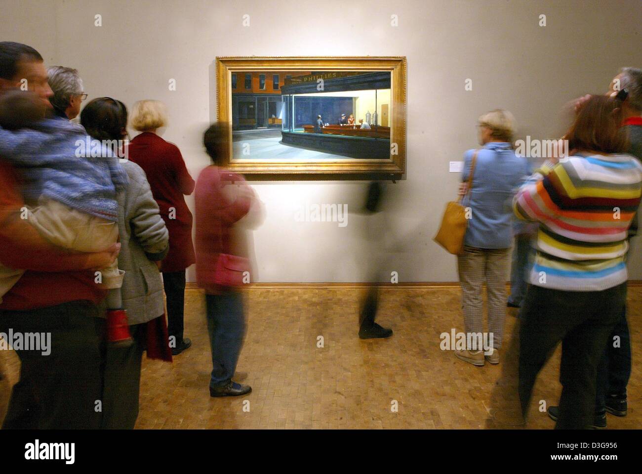 (dpa) - Visitors look at Edward Hopper's painting 'Nighthawks' at the museum Ludwig in Cologne, Germany, 16 November 2004. The Hopper retrospective will be on view until 9 January 2005. Stock Photo