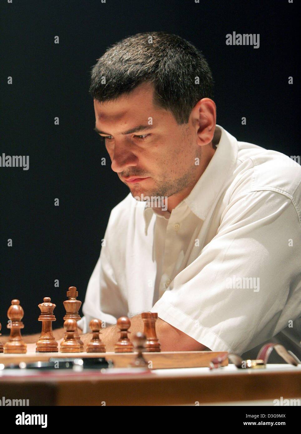 (dpa) - Defending champion Viorel Bologan from Moldova sits in front of a chess board during the 2004 Dortmund Chess Meeting in Dortmund, Germany, 23 April 2004. The event takes place at the Dortmund Theatre from 22 July to 1 August. Stock Photo
