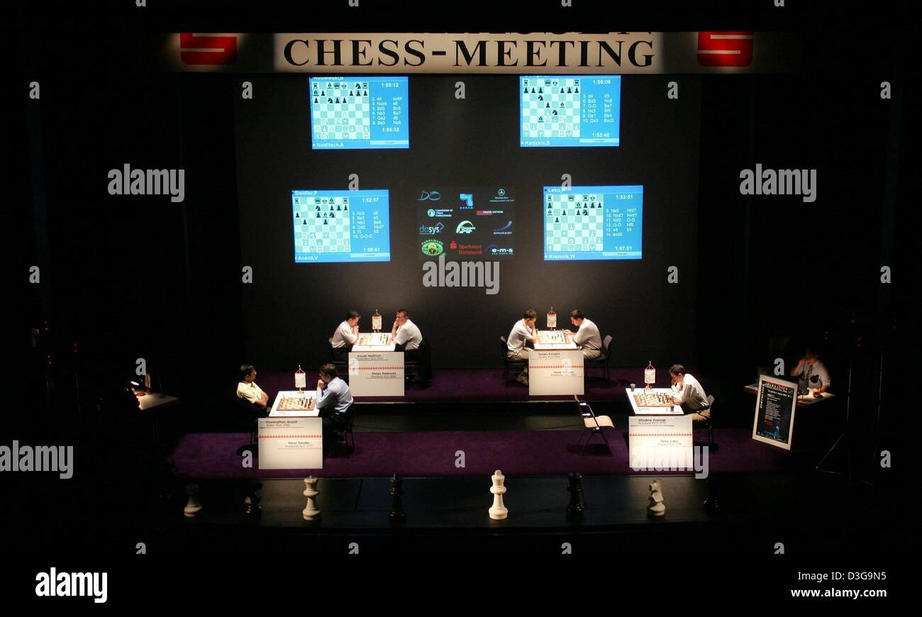 Chess boxers Arik Braun (R) and Felix Bartels sit in front of a chequer  board during the Chess Boxing Championships in Berlin, Germany, 28 July  2012. The chess boxing event took place