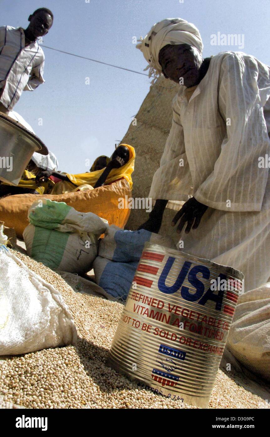 (dpa) - Food from an aid programme is distributed in a refugee camp in Nyala, in the province of Darfur, Sudan, Tuesday, 13 July 2004. Arab militiamen are terrorising the local population. Stock Photo