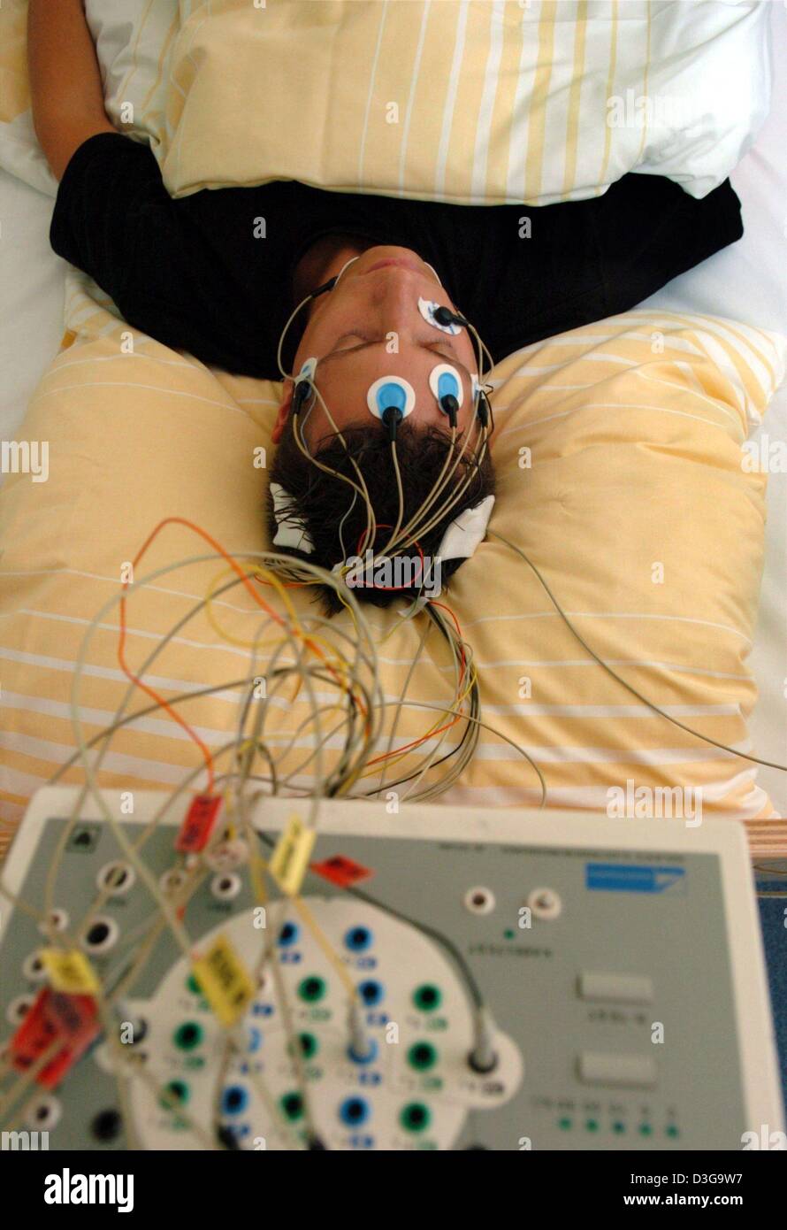 (dpa) A patient who has electrodes fixed to his head lies in a bed of