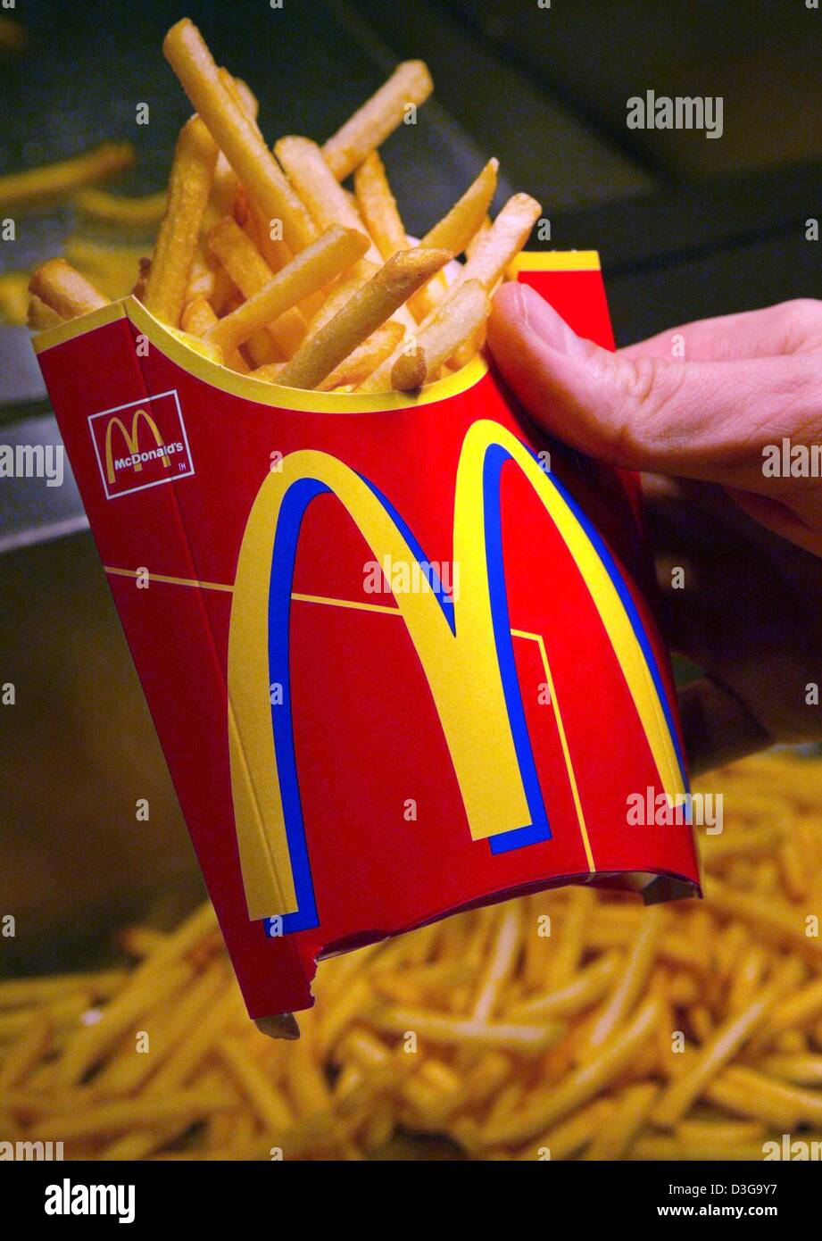 (dpa files) - A serving of french fries is prepared by an employee at a McDonald's fast food restaurant in Munich, Germany, 1 March 2004. After decreasing 2003 profits McDonald's, which operates more than 1,200 restaurants in Germany, was able to record a small increase in early 2004 due to a revamped menue and agressive marketing. Stock Photo
