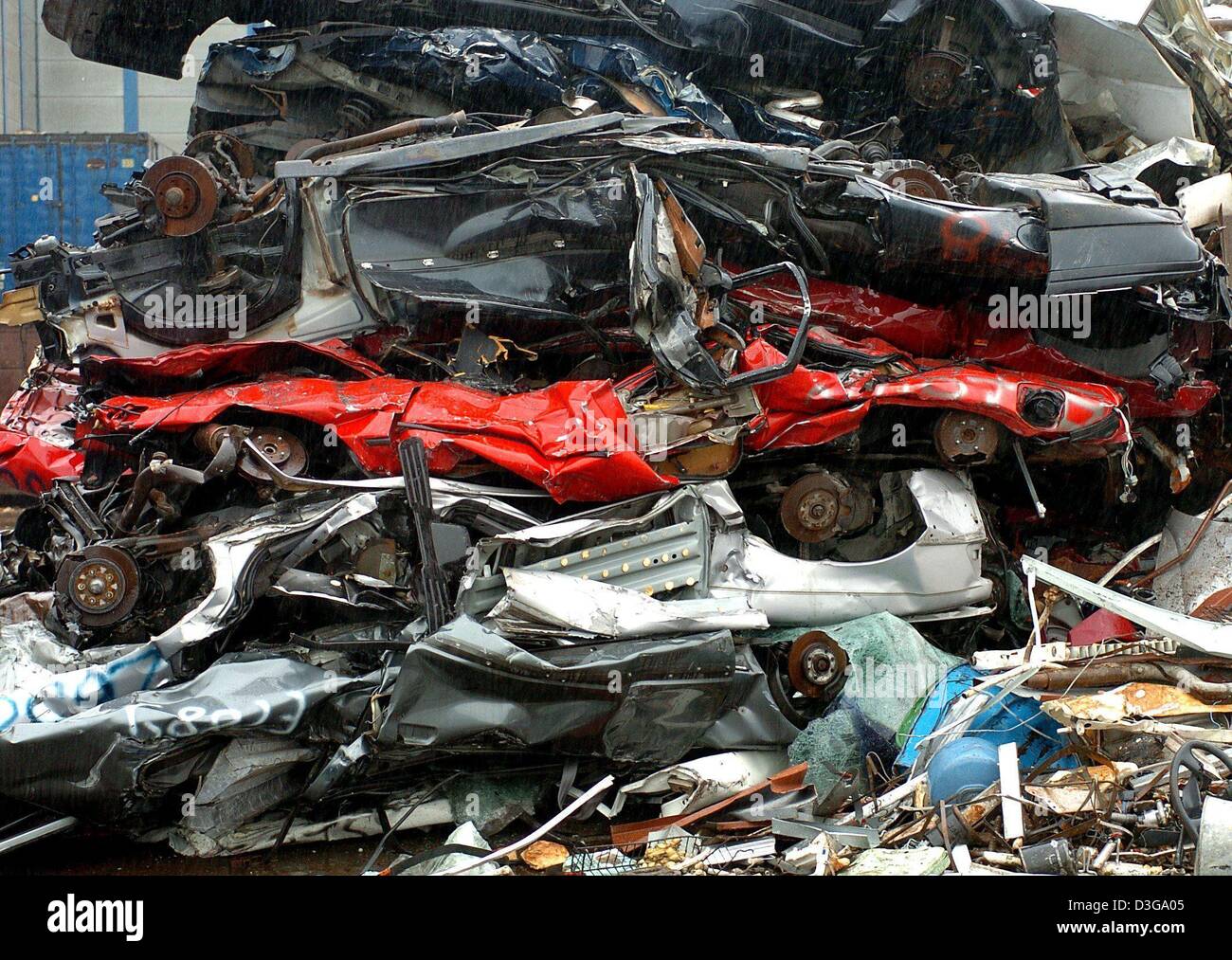 (dpa) - Compressed car wrecks are piled up at Interseroh scrap trade in ...