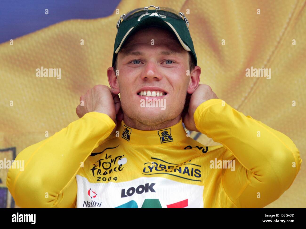 (dpa) - Norwegian cyclist Thor Hushovd of team Credit Agricole smiles after receiving the yellow jersey of the overall leader after the second stage of the Tour de France in Namur, Belgium, 5 July 2004. The second and 197km long stage of the 91st Tour de France cycling race took the cyclists from Charleroi to Namur. A second place finish in the stage was enough for Hushovd to take  Stock Photo