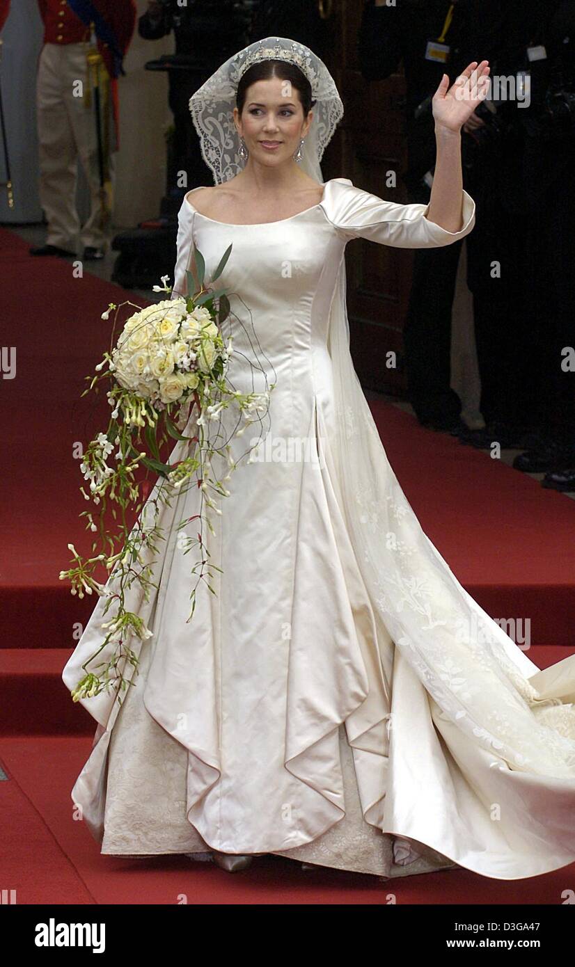 (dpa) - Mary Donaldson, bride of Danish crown prince Frederik, smiles and waves her hand as she stands dressed in her wedding dress in front of the cathedrale in Copenhagen, Denmark, Friday, 14 May 2004. The church wedding of crown prince Frederik and Mary Donaldson from Australia has started today. Members of all European royal dynasties are among the 800 invited guests who attend Stock Photo