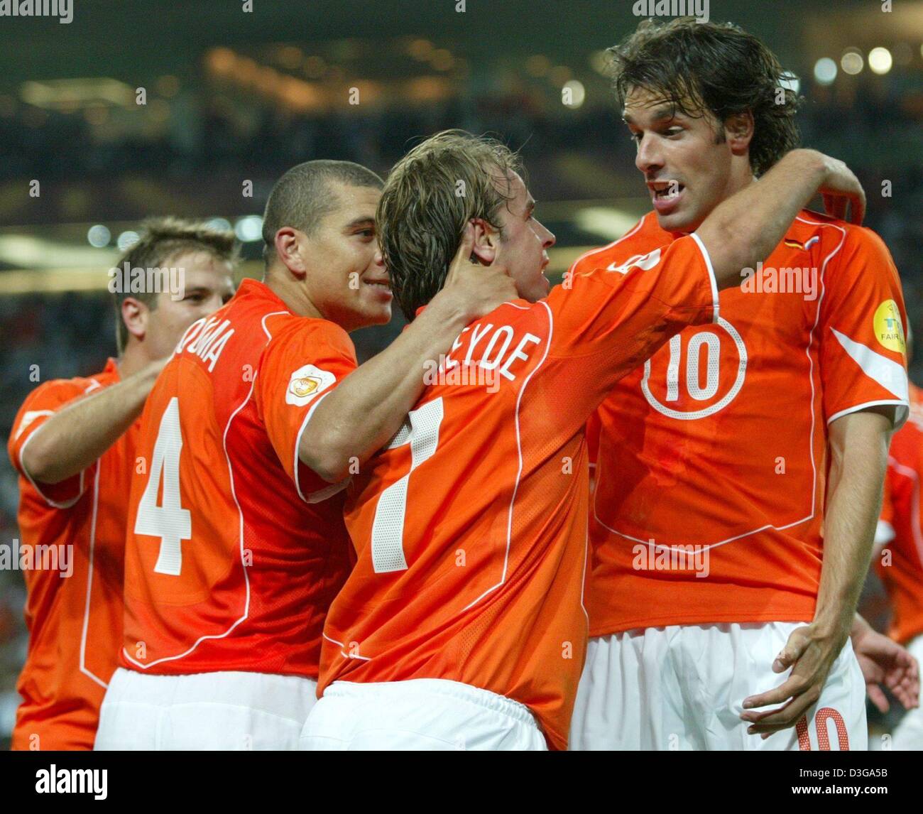 (dpa) - Dutch forward Ruud van Nistelrooy (R), who had scored the 1-1 equalizer moments earlier, celebrates with his teammates (L-R) Rafael van der Vaart, Wilfried Bouma und Andy van der Meyde during the Soccer Euro 2004 group D game between Germany and the Netherlands at the Dragao Stadium in Porto, Portugal, 15 June 2004. The game ended in a 1-1 draw. +++NO MOBILE APPLICATIONS ++ Stock Photo