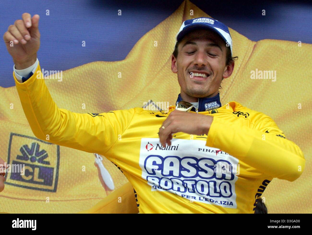 (dpa) - Swiss Fabian Cancellara of team Fassa Bortolo puts on the race leader's yellow jersey after the first stage of the Tour de France in Charleroi, Belgium, 4 July 2004. 23-year-old Cancellara did also win the prologue of the Tour de France the day before. The first and 202.5km long stage of the 91st Tour de France cycling race took the cyclists from Liege to Charleroi. Stock Photo
