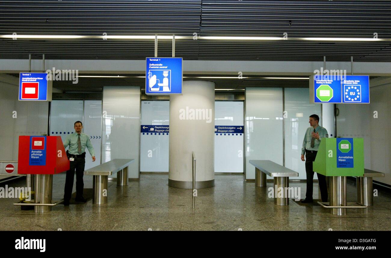 (dpa) - Two customs officers stand at a customs checkpoint and wait for travellers at the airport in Frankfurt, Germany, 20 April 2004. In the past, several customs checkpoints at Germany's largest airport had been unoccupied, but officials claimed that supervision had been sufficient due to random checks that were regularly performed. Stock Photo
