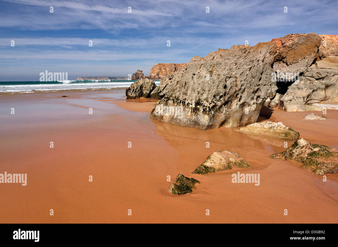 Portugal, Algarve: Rock formations and  ebb tide at beach Praia do Tonel with Cape St. Vincent in the background Stock Photo