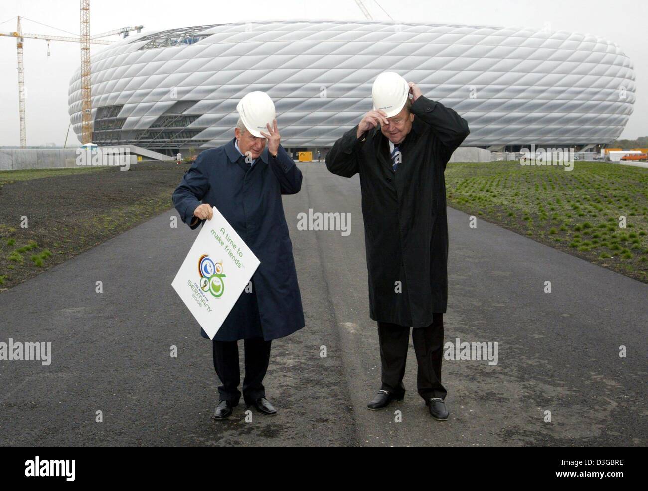 (dpa) Lennart Johansson (R), Swedish President of UEFA and FIFA World Cup Organising Committee Chairman, and Senes Erzik from FIFA delegation visit the construction site of the Allianz Arena in Munich, Germany, 2 November 2004. With an inspection tour in Frankfurt, Munich and Berlin the delegation wants to get an idea of the building progress of the soccer stadiums which will be th Stock Photo
