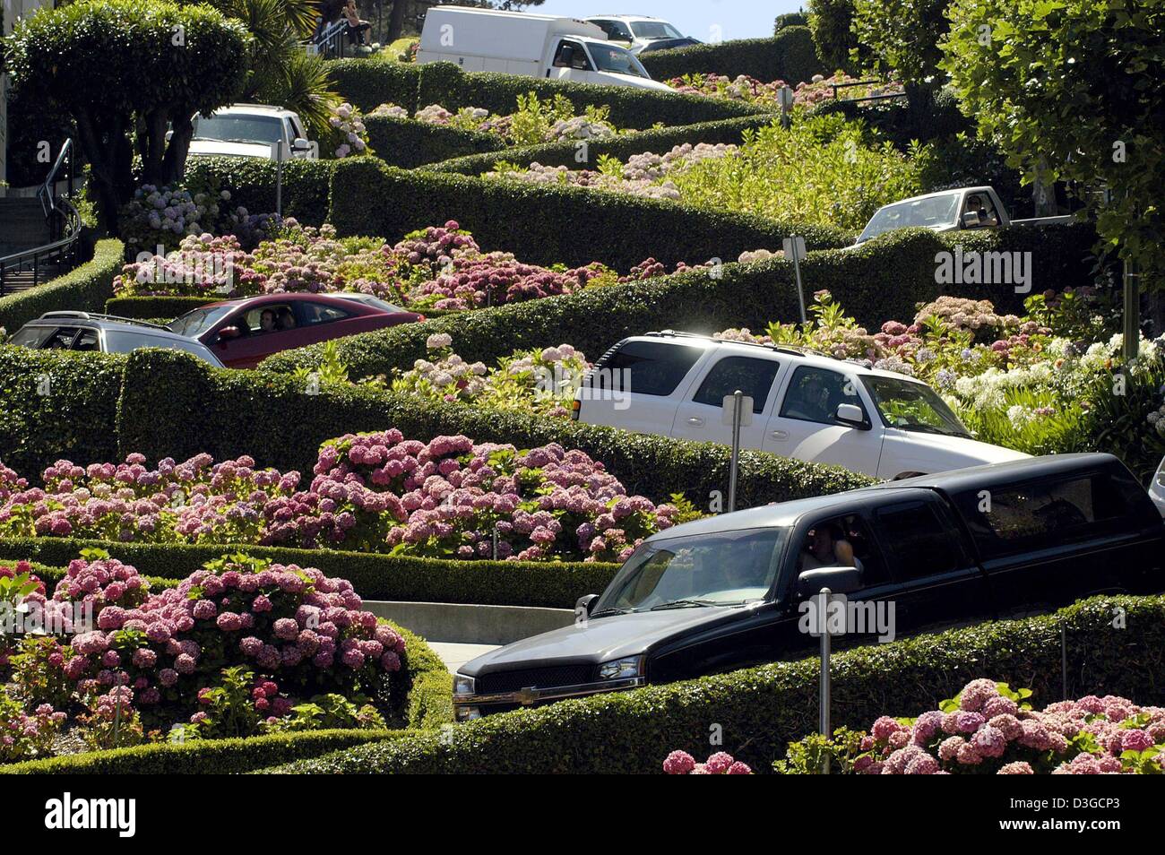 (dpa) - Cars head down scenic Lombard Street in the northern Californian city of San Francisco, USA, 20 July 2004. Lombard Street is San Francisco's crookedest street.ÊThe steep, hilly street was created with sharp curves to switchback down the one-way hill past beautiful Victorian mansions.ÊIt is paved with bricks and is an amazing site and beloved tourist attraction. Stock Photo
