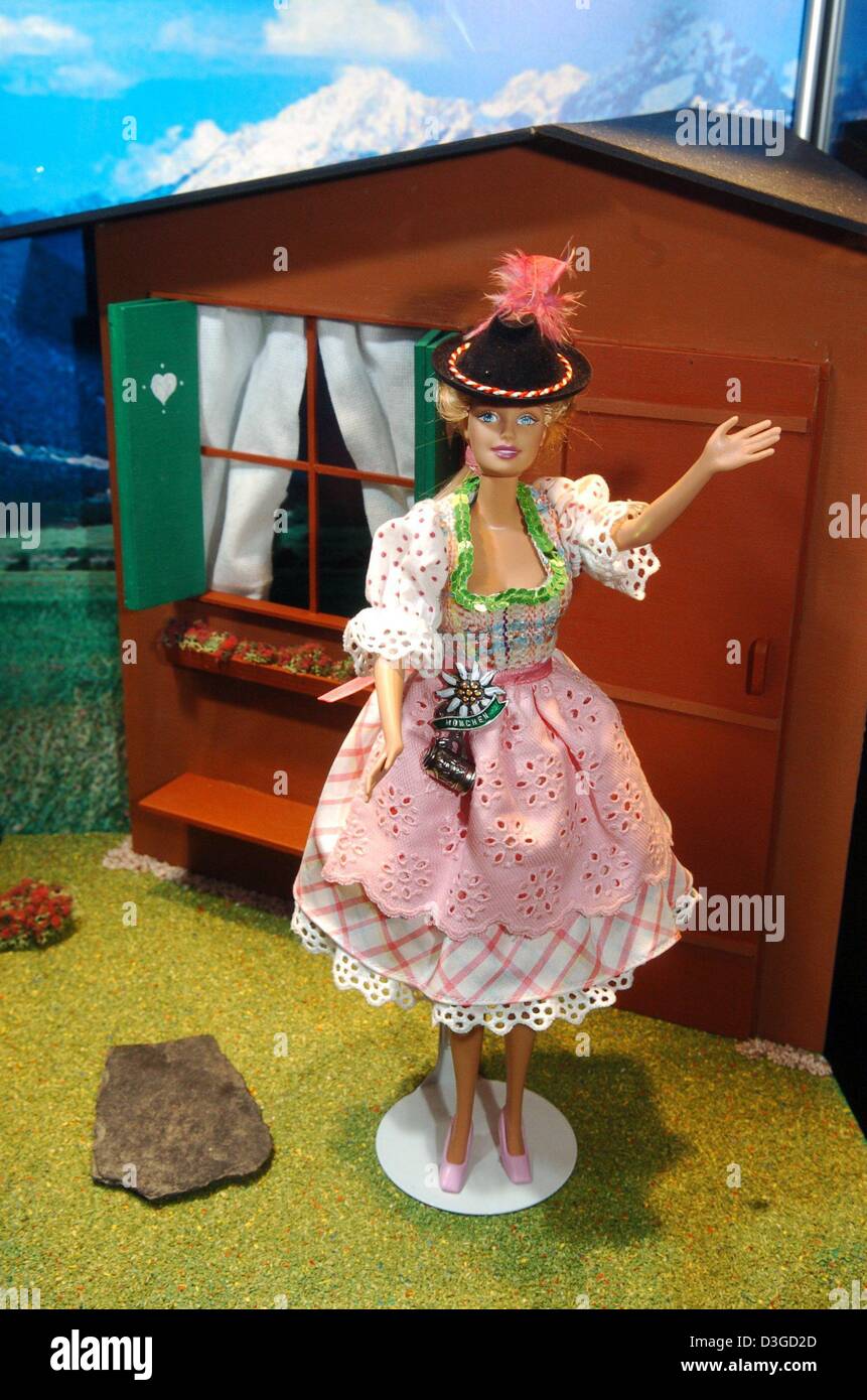(dpa) - A Barbie doll wearing a Bavarian dirndl dress (designed by Rena Lange chief designer James Waldron) is seen in front of a Bavarian-style cottage at the exhibition 'World of Barbies' in Munich, Germany, 7 October 2004. Altogether about 1,000 Barbie dolls are presented, including rare, expensive and specially designed collector dolls. The exhibition, commemorating Barbie's 45 Stock Photo