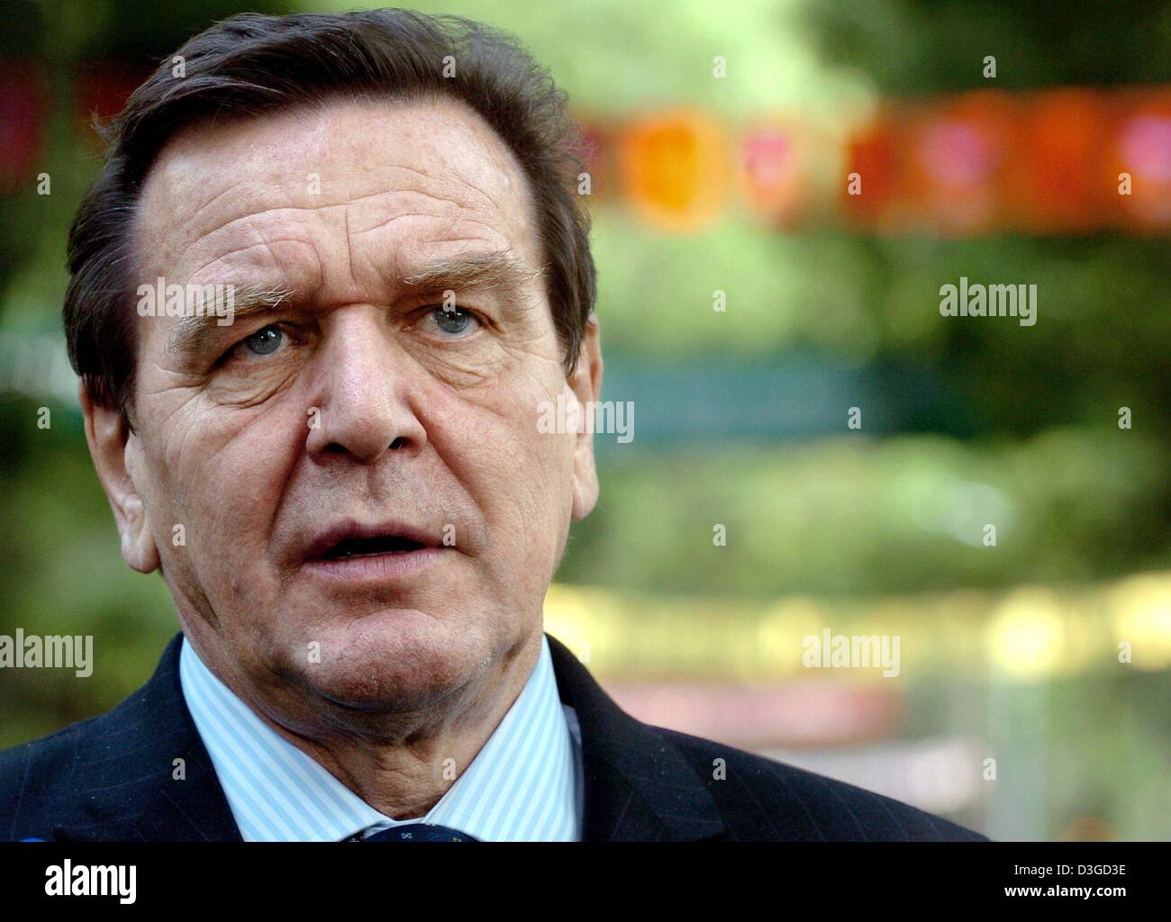 (dpa) - German Chancellor Gerhard Schroeder comments on the new bomb attempts in the Afghan capital Kabul on the sidelines of the 5th Asia Europe Meeting (ASEM 5) in Hanoi, Vietnam, Friday, 8 October 2004. German Chancellor Gerhard Schroeder said Friday he plans to stick with his plans to travel to Afghanistan, despite a rocket explosion just a few metres from the German embassy in Stock Photo