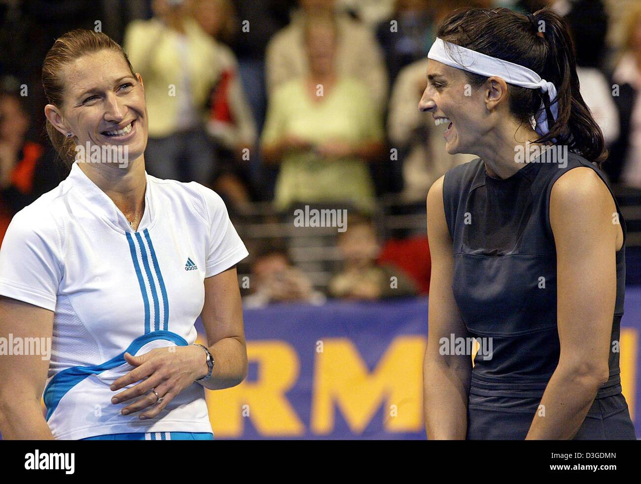 dpa) - Former tennis players Steffi Graf (L) and Gabriela Sabatini share a  laugh after their exhibition match at Max Schmeling Halle in Berlin, 25  September 2004. Steffi Graf, who resigned from