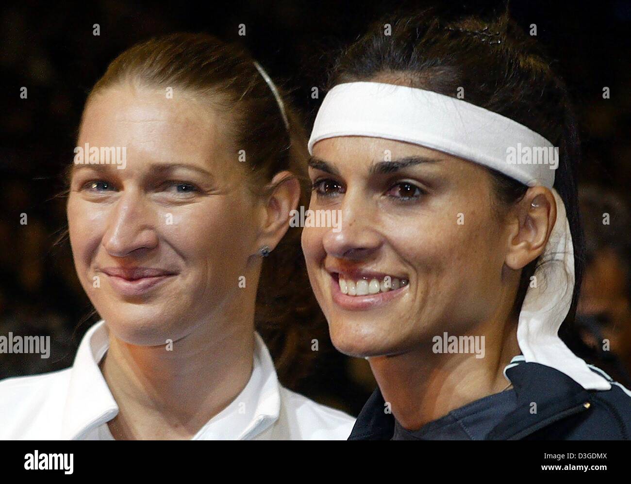 dpa) - Former tennis players Steffi Graf (L) and Gabriela Sabatini smile  after their exhibition match at Max Schmeling Halle in Berlin, 25 September  2004. Steffi Graf, who resigned from her professional