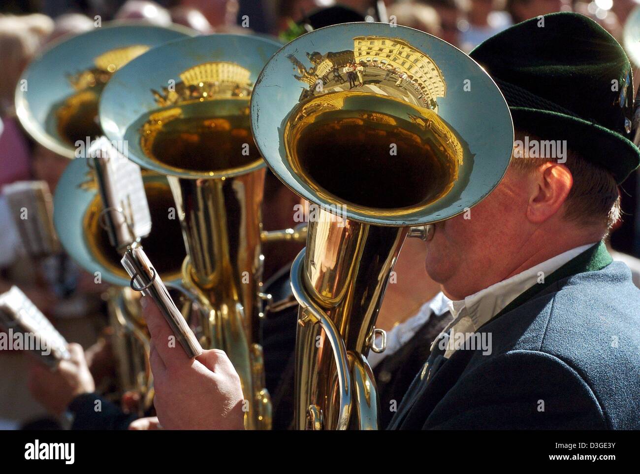 (dpa) - The Theatiner church is reflected in the instruments of three tuba players during a parade to mark the beginning of the Oktober Fest in downtown Munich, 19 September 2004. Six million people are expected to visit the Munich Oktoberfest, which is one of the world's biggest and most famous festivals. The beer fest runs until 3 October. Stock Photo