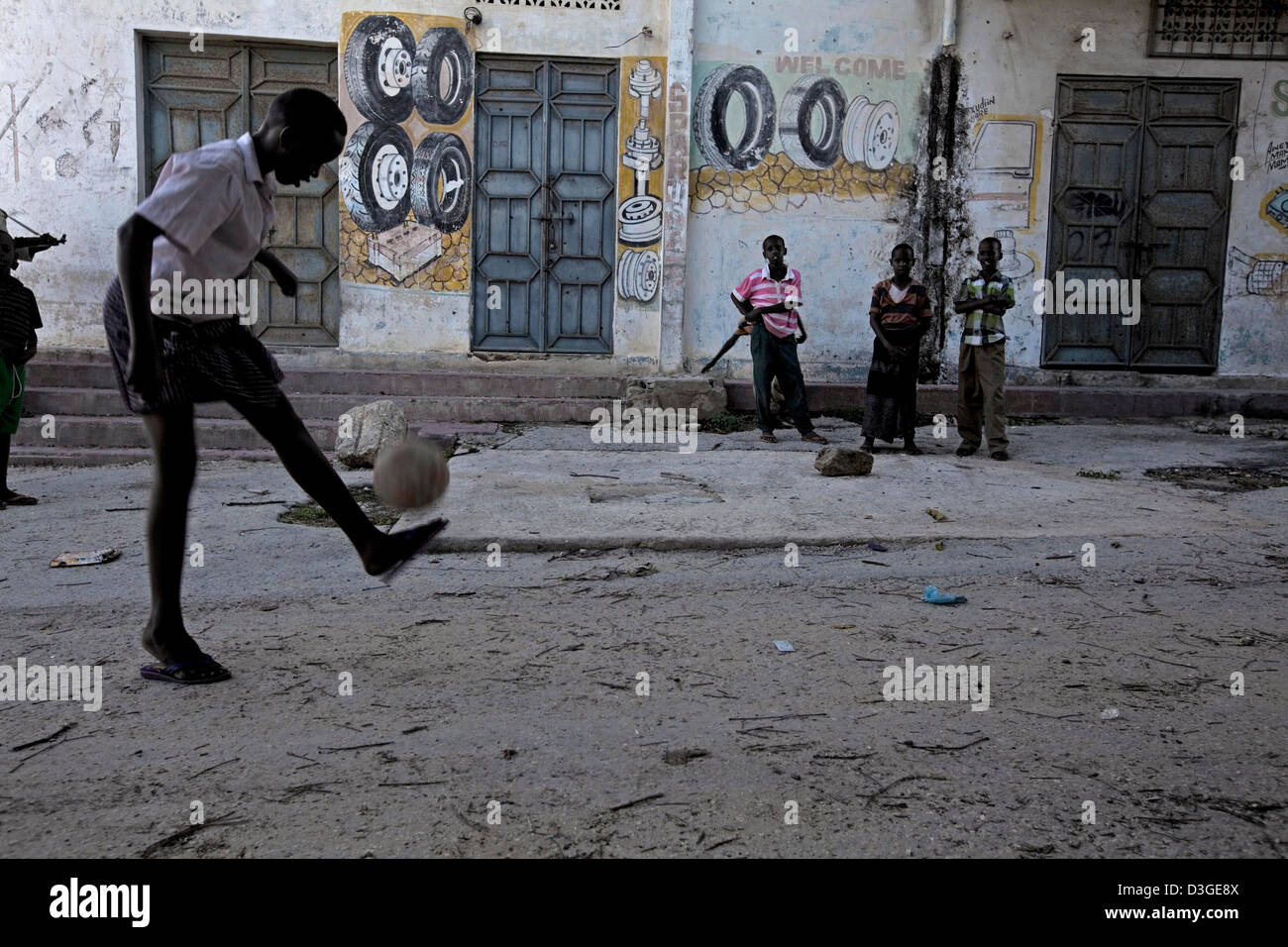 Children playing football in the streets of downtown Mogadishu. Stock Photo