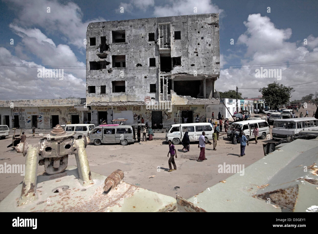 A building riddled with mortar and bullet potholes in downtown Mogadishu, Somalia taken from an AMISOM Casper armoured vehicle. Stock Photo