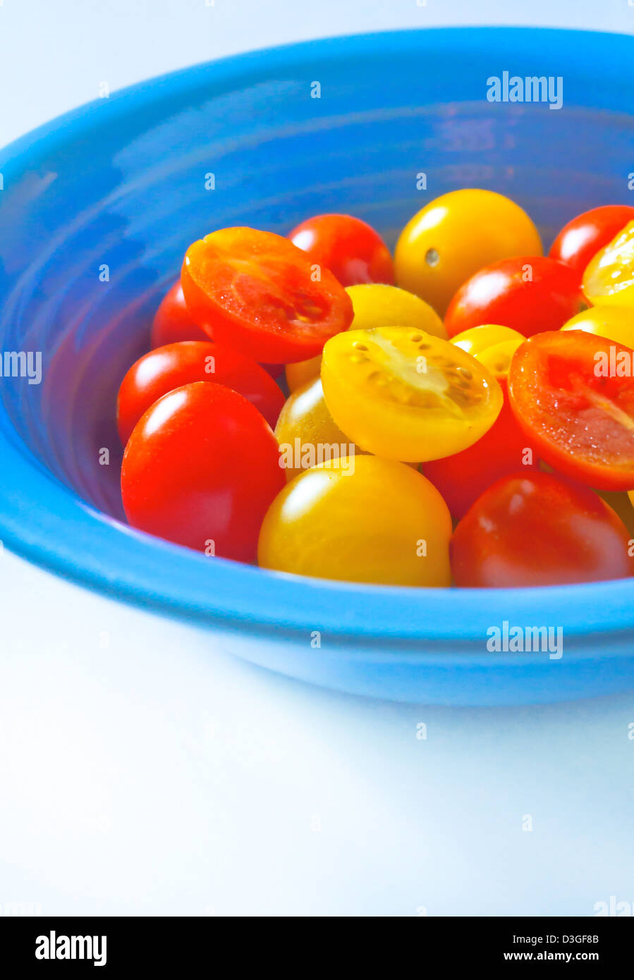Red and Yellow cherry tomatoes in the blue plate Stock Photo - Alamy