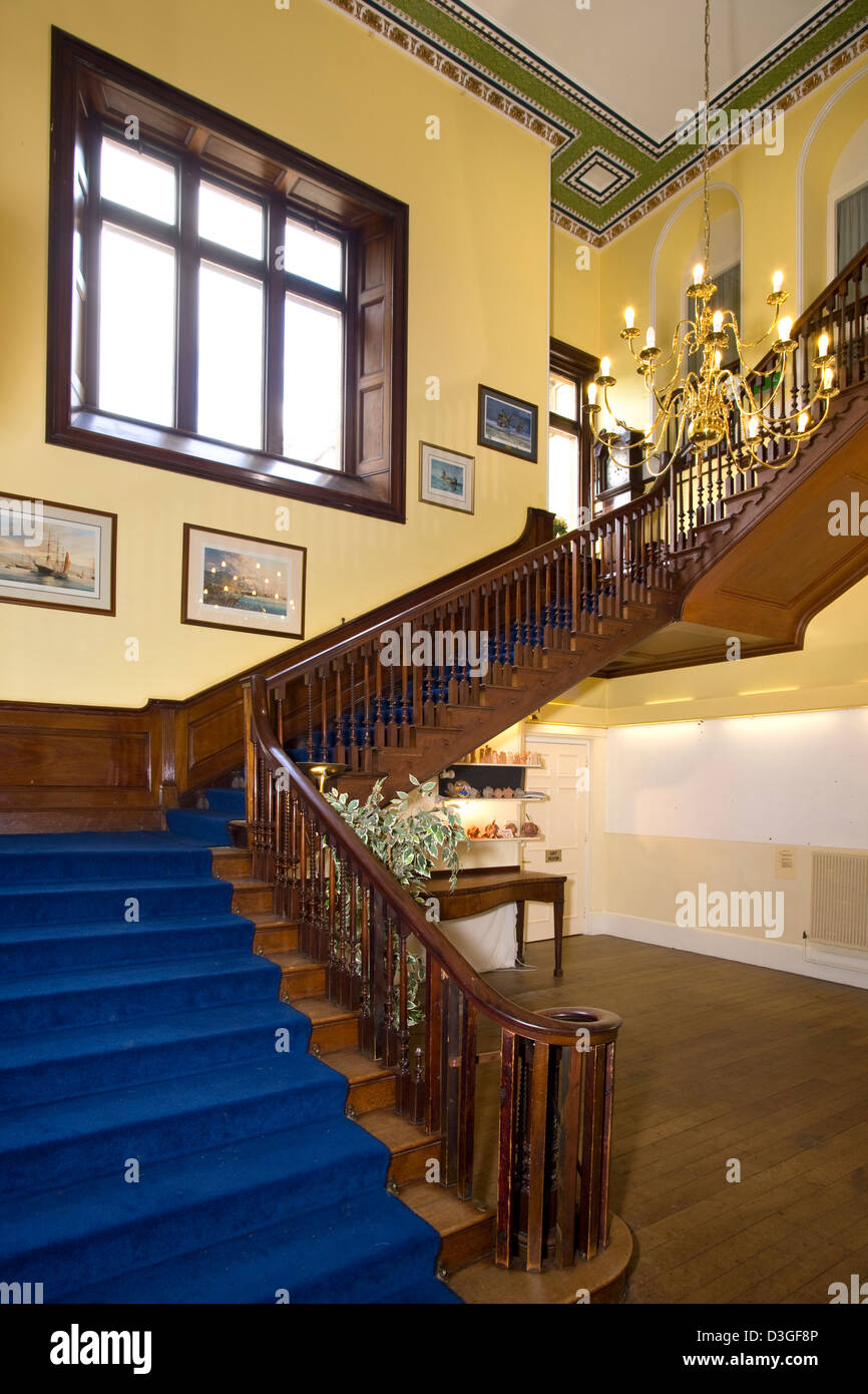Hall and imposing staircase in a redundant private school building. Stock Photo