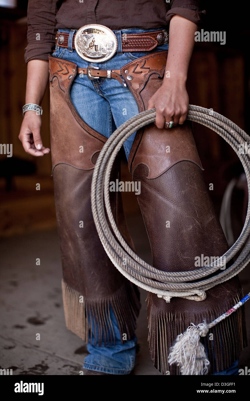 Cowgirl wrangler in leather chaps, with lasso, ranching, Montana, USA Stock Photo