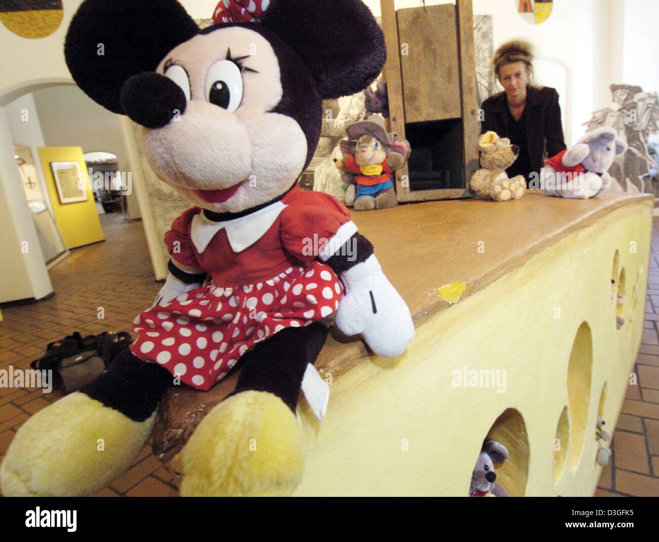 (dpa) - A Minnie Mouse doll sits on top of an oversized piece of cheese during the 'Mouse, Man and Mouse Trap' exhibition at Grafschafter Museum at Moers Castle, Germany, 20 August 2004. Next to plush, metal and paper mice there will also be many mouse drawings on display at the exhibition which lasts until 1 November 2004. Stock Photo