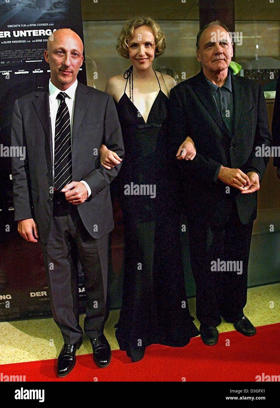 (dpa) - Director Oliver Hirschbiegel (L) and actors Juliane Koehler (C) and Bruno Ganz pose in front of the posters for their film 'The Downfall: Hitler and the End of the Third Reich' which premiered in Munich, 9 September 2004. The film, which deals with the last days in the life of Adolf Hitler, celebrated its world premiere and is going to be released in Germany on 16 September Stock Photo