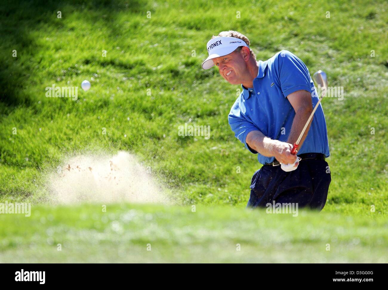 (dpa) - Golfer Colin Montgomerie from Scotland plays a bunker shot during the 17th Linde German Masters tournament in Pulheim near Cologne, Germany, on Thursday, 9 September 2004. Stock Photo