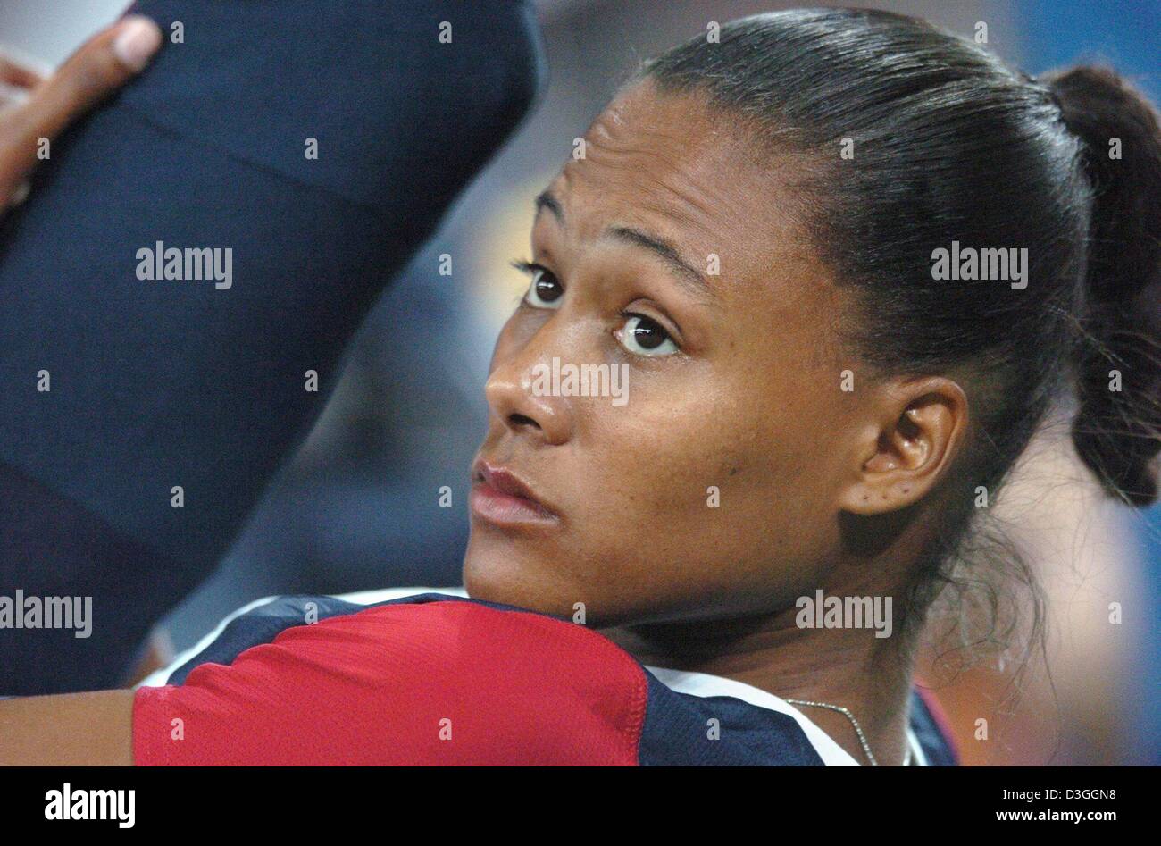 (dpa) - Marion Jones from the USA concentrates before her start in the women's 4x100m relay qualifying heat in the Olympic stadium at the Athens 2004 Olympic Games, Thursday 26 August 2004. Stock Photo