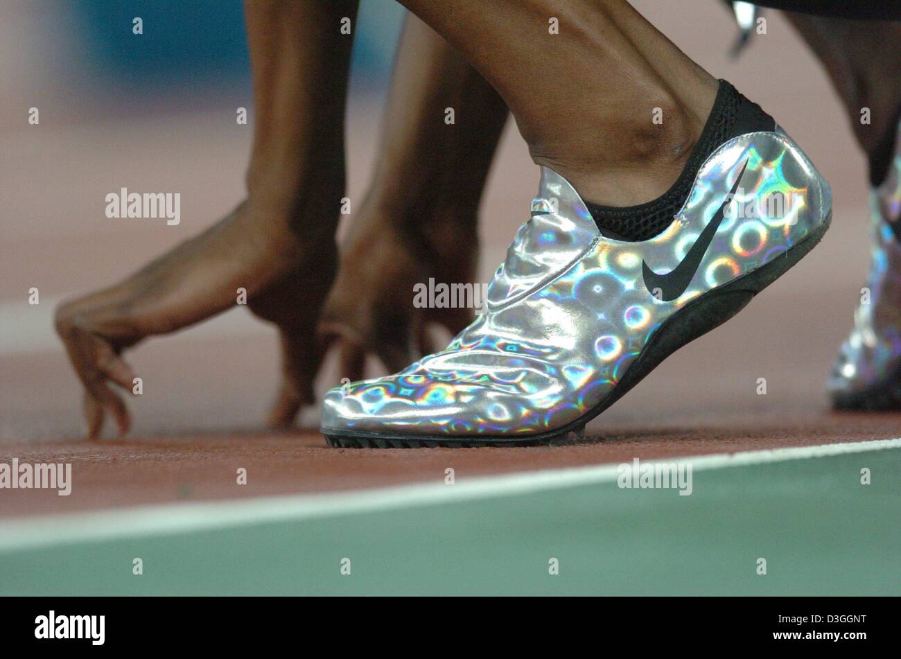 (dpa) - A view of the spikes of Marion Jones from the USA as she concentrates before her start in the women's 4x100m Relay qualifying heat in the Olympic Stadium at the Athens 2004 Olympic Games, Thursday 26 August 2004. Stock Photo