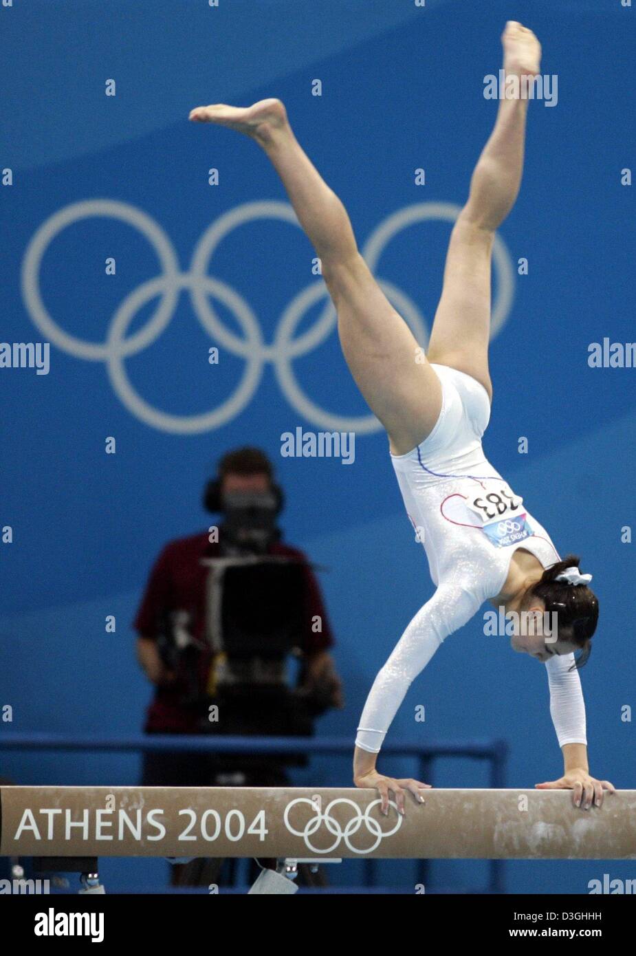 (dpa) - Romania's Catalina Ponor on the balance beam at the women's team final in gymnastics at the 2004 Olympic Games in the Hellinikon Indoor Arena in Athens, Tuesday 17 August 2004. Romania won the gold medal. Stock Photo