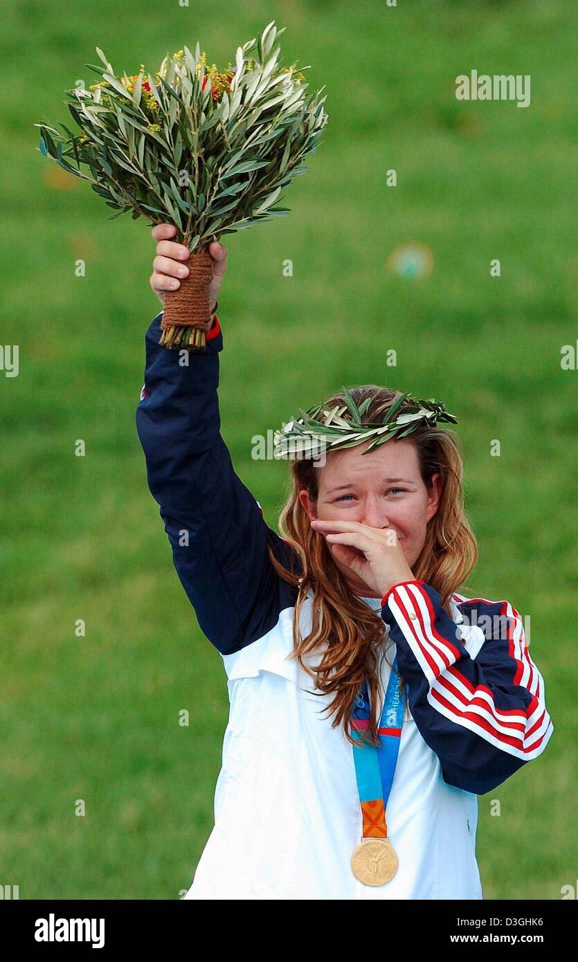 (dpa) - Gold medal winner Kimberly Rhode from from US cheers with a bunch of flowers in her hand during the medal ceremony of the Double Trap Shooting at the 2004 Olympic Games, Athens, Greece,  18 August 2004. Stock Photo