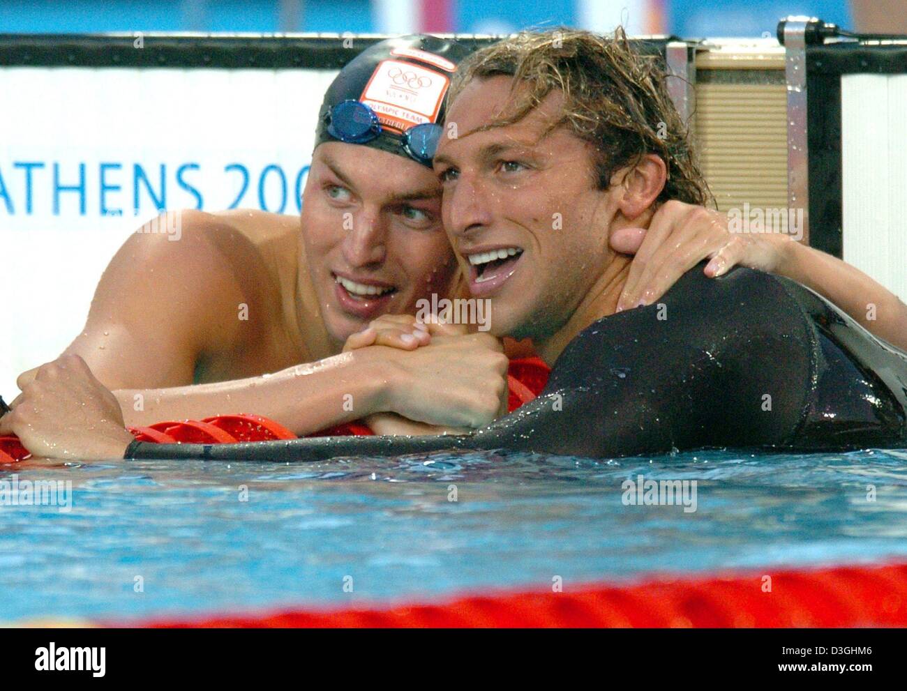 (dpa) - (from L:) Dutch Pieter van den Hoogenband congratulates Australian swimmer Ian Thorpe after he won the men's 200m freestyle final at the Olympic Aquatic Centre in Athens, Monday 16 August 2004. US Michael Phelps became third. Stock Photo