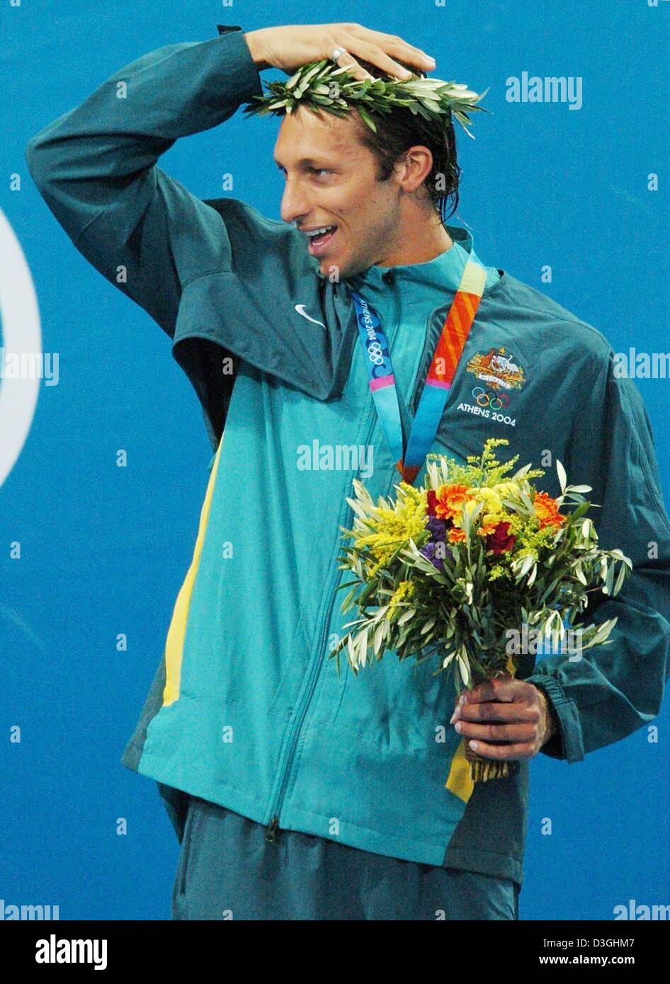 (dpa) - Australian swimmer Ian Thorpe adjusts his laurel crown during the medal ceremony after he took the gold in the men's 200m freestyle final at the Olympic Aquatic Centre in Athens, Monday 16 August 2004. Stock Photo