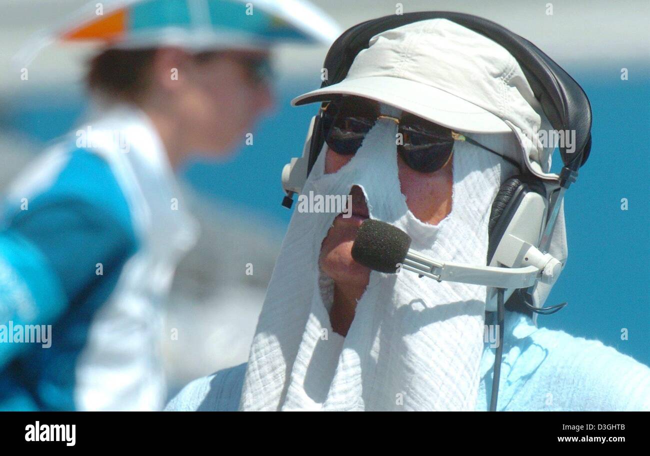 (dpa) - A TV commentator protects himself from the heat at the Olympic ...