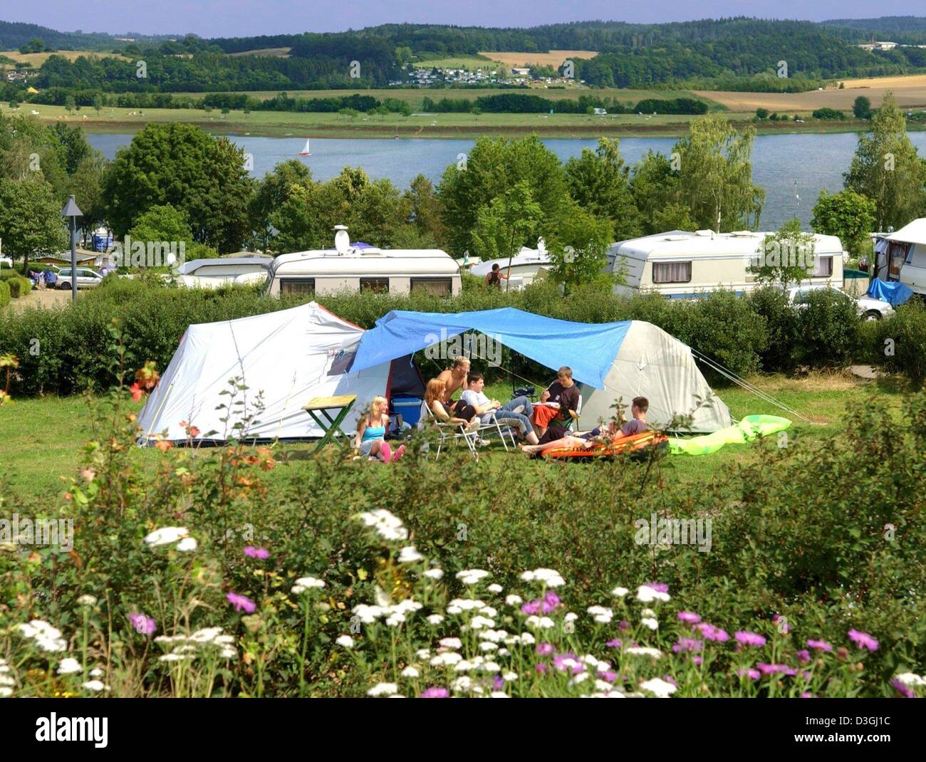 (dpa) - A group of young people are spending their holidays on the Gunzenberg camping site near Poehl dam, eastern Germany, 5 August 2004. The reservoir lake is one of the most attractive destinations for tourists in the Vogtland region. Stock Photo