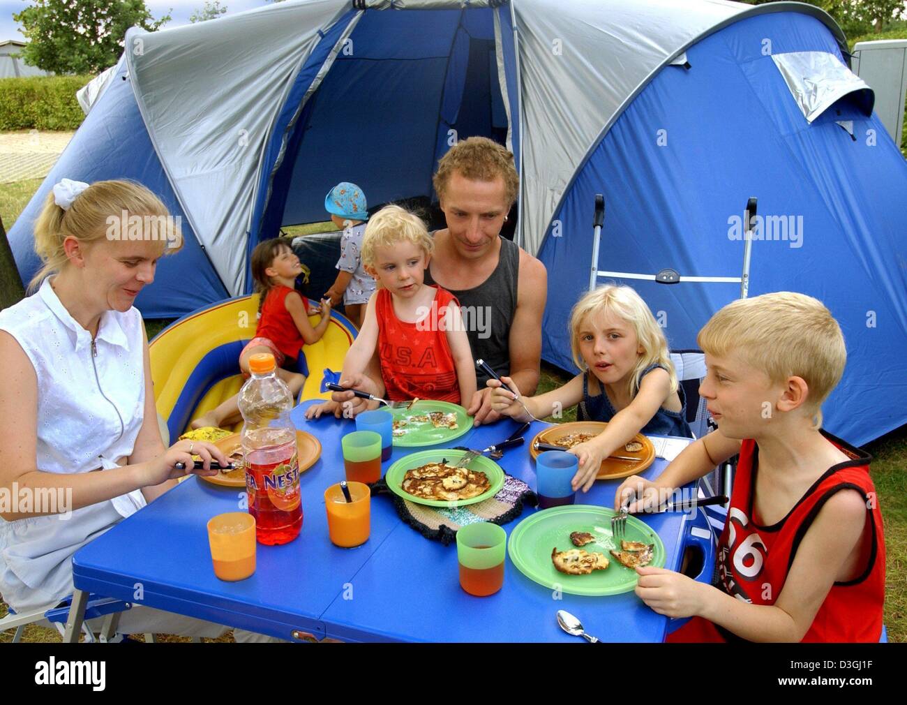 (dpa) - The Schimke family eat their pancakes during their holidays on the Gunzenberg camping site near Poehl dam, eastern Germany, 5 August 2004. The reservoir lake is one of the most attractive destinations for tourists in the Vogtland region. Stock Photo