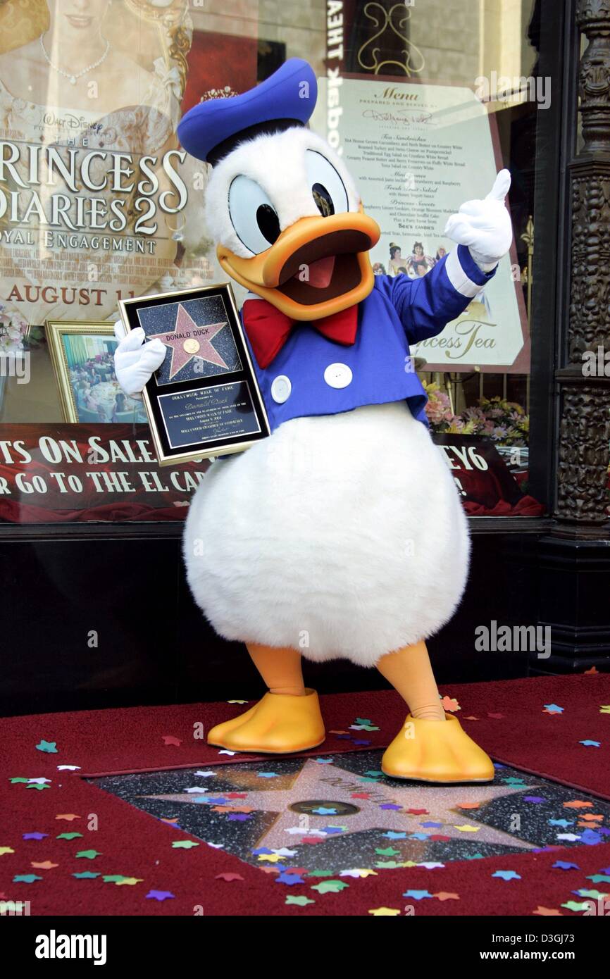 (dpa) A person dressed as Donald Duck poses in front of his newly