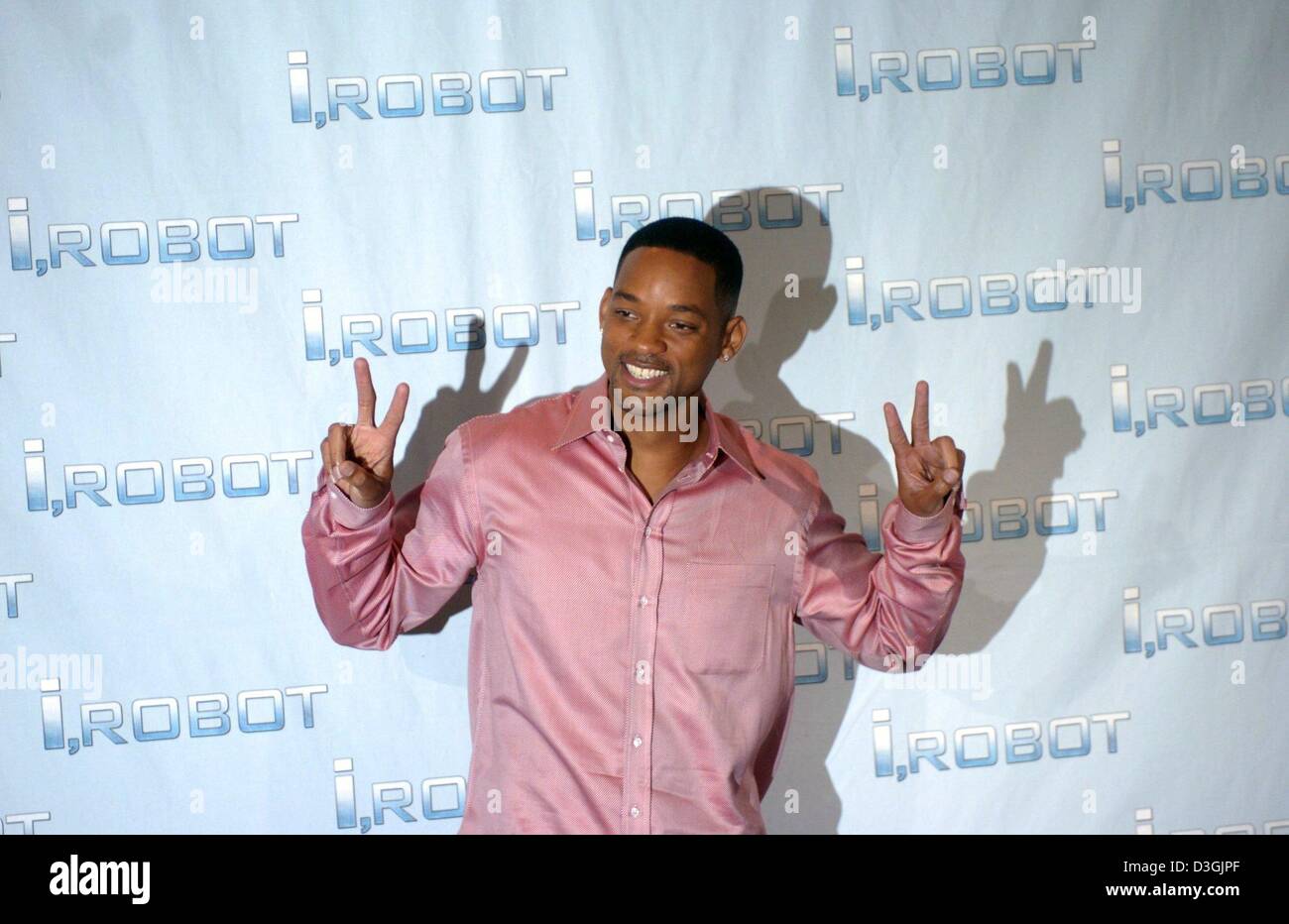 (dpa) - US actor Will Smith smiles and poses as he promotes his new film 'I, Robot' during a photo opportunity in Berlin, Monday, 02 August 2004. In the sci-fi action thriller, directed by Alex Proyas, Smith plays the part of a cyber-cop who fights power-hungry robots. The film is going to be released in Germany on 5 August 2004. Stock Photo