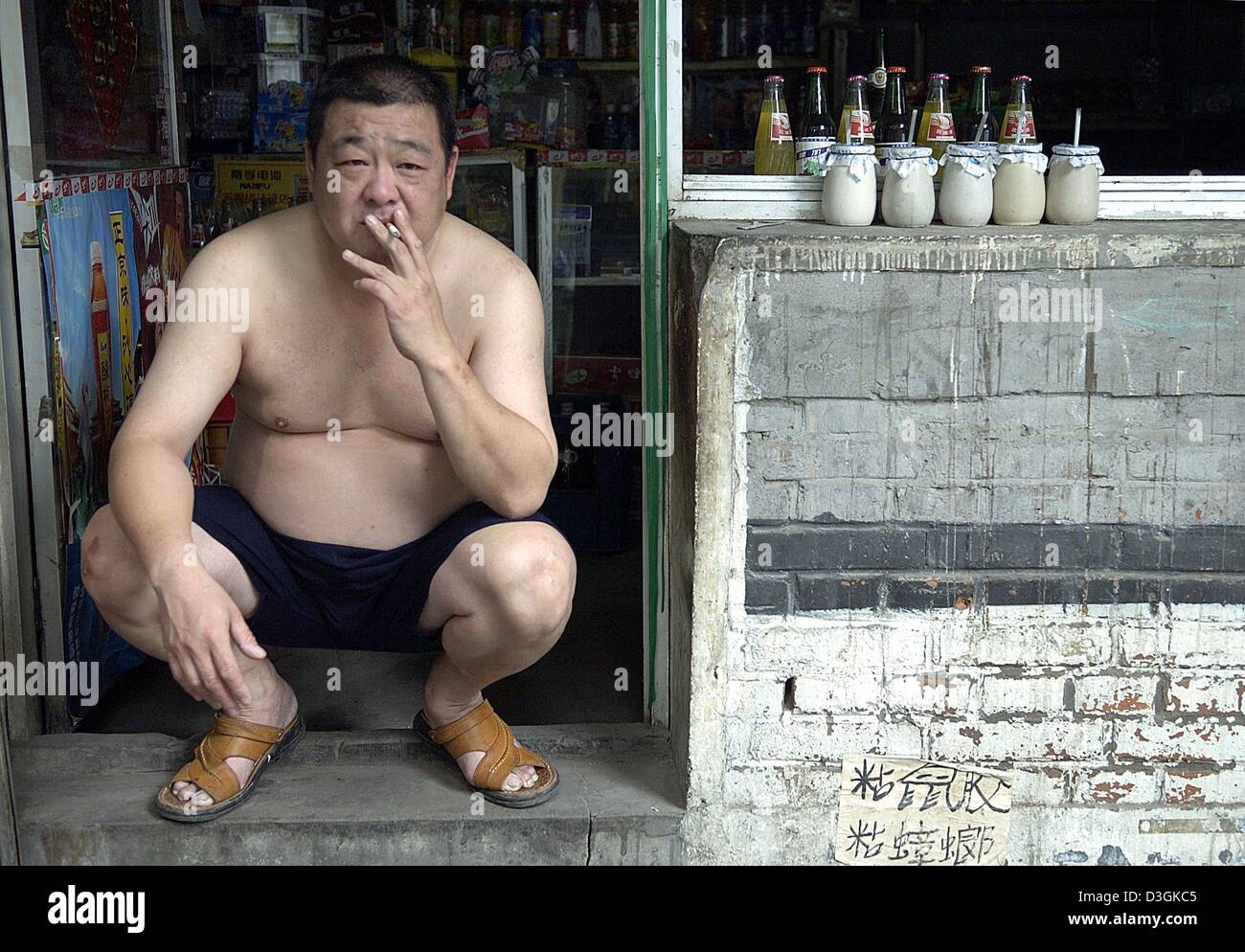 asian squat smoking cigarette dpa)