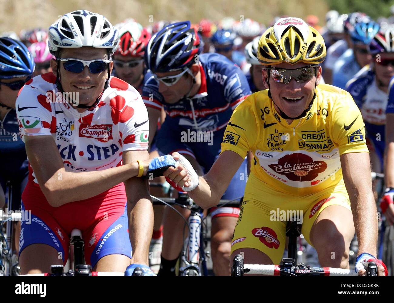 (dpa) - French cyclists Thomas Voeckler of team Brioches La Boulangere, wearing the yellow jersey of the overall leader, and Richard Virenque of team Quick Step-Davitamon, wearing the polka-dotted jersey of the best climber, await the start of the 11th stage of the Tour de France cycling race in Saint-Flour, France, 15 July 2004. The 164km long stage leads the cyclists from Saint-F Stock Photo