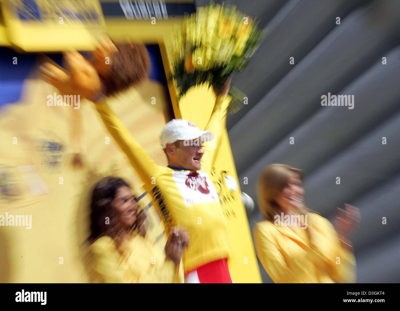 (dpa) - 25-year-old French cyclist Thomas Voeckler of team Brioches La Boulangere celebrates on the podium after putting on the race leader's yellow jersey after the ninth stage of the Tour de France cycling race in Gueret, France, 13 July 2004. The 160.5km long stage took the cyclists from Saint-Leonard-de-Noblat to Gueret. During the 10th stage Voeckler wears the yellow jersey fo Stock Photo