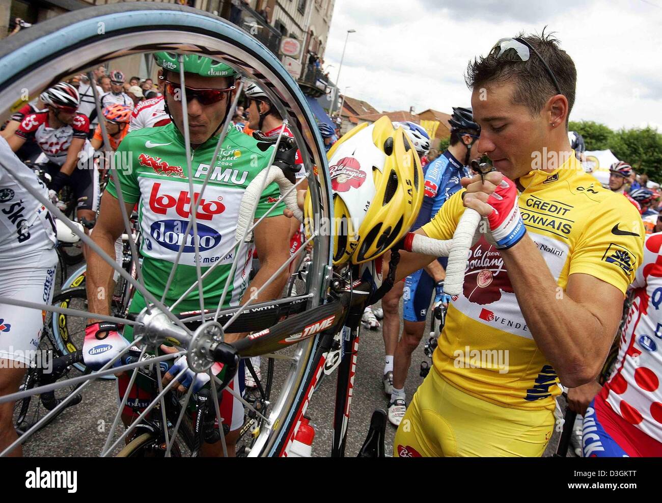 (dpa) - Australian cyclist Robbie McEwen (L) of team Lotto-Domo, wearing the green jersey of the best sprinter, and French cyclist Thomas Voeckler of team Brioches La Boulangere, wearing the yellow jersey of the best overall leader, await the start of the 9th stage of the Tour de France cycling race in Saint-Leonard-de-Noblat, France, 13 July 2004. The 160.5 km long stage from Sain Stock Photo
