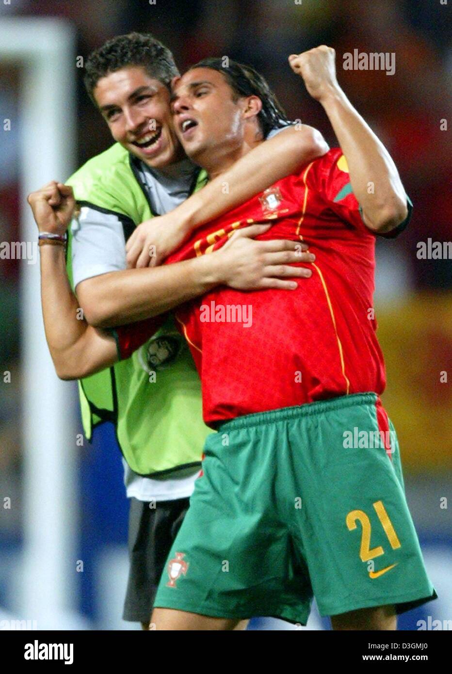 (dpa) - Portuguese forward Nuno Gomes (R) cheers and is hugged by goalkeeper Jose Filipe Moreira (L), who sat on the substitute bench, after the final whistle of the Euro 2004 semi final game opposing Portugal and the Netherlands in Lisbon, Portugal, 30 June 2004. Portugal eliminated the Netherlands with a 2-1 win, achieving its first ever qualification for the European final.  +++ Stock Photo