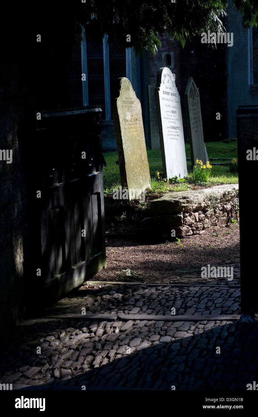 Stoke Gabriel church,graves gravestones,cobbles,Gate,ancient, ancient  churchyard,yew, gate, grass, anglican, architecture, beli Stock Photo
