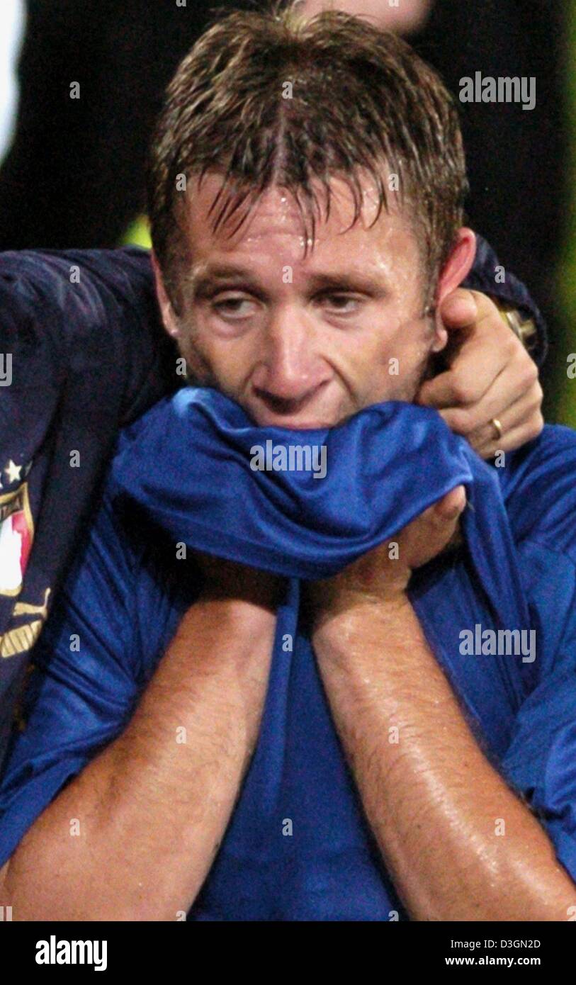 (dpa) - Italy forward Antonio Cassano is inconsolable after the end of the game. The Italian national soccer team wins their final Euro 2004 group C match against Bulgaria at Estadio Dom Afonso Henrique in Guimaraes, Portugal, 22 June 2004. Cassano had scored the winning goal in injury time to ensure a last minute victory but the 2-1 win was not enough to keep the undefeated Italia Stock Photo