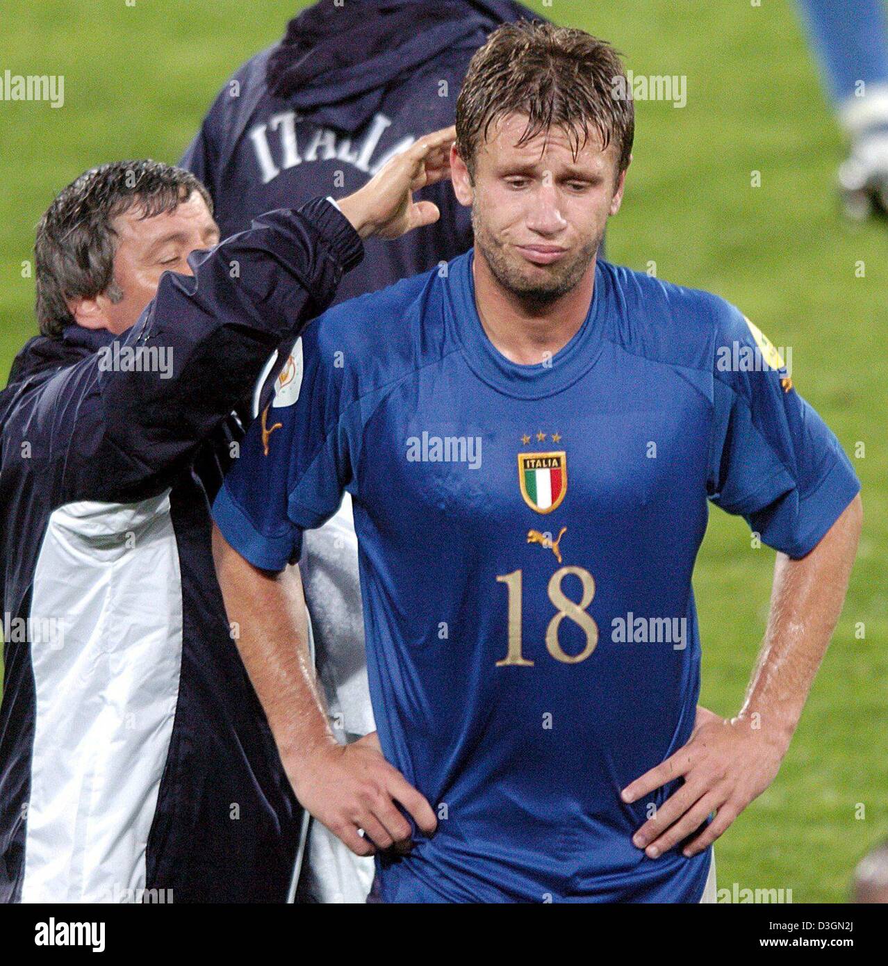 (dpa) - Italy forward Antonio Cassano (R) is inconsolable as he walks off the pitch after the end of the game. The Italian national soccer team wins their final Euro 2004 group C match against Bulgaria at Estadio Dom Afonso Henrique in Guimaraes, Portugal, 22 June 2004. Cassano had scored the winning goal in injury time to ensure a last minute victory but the 2-1 win was not enough Stock Photo