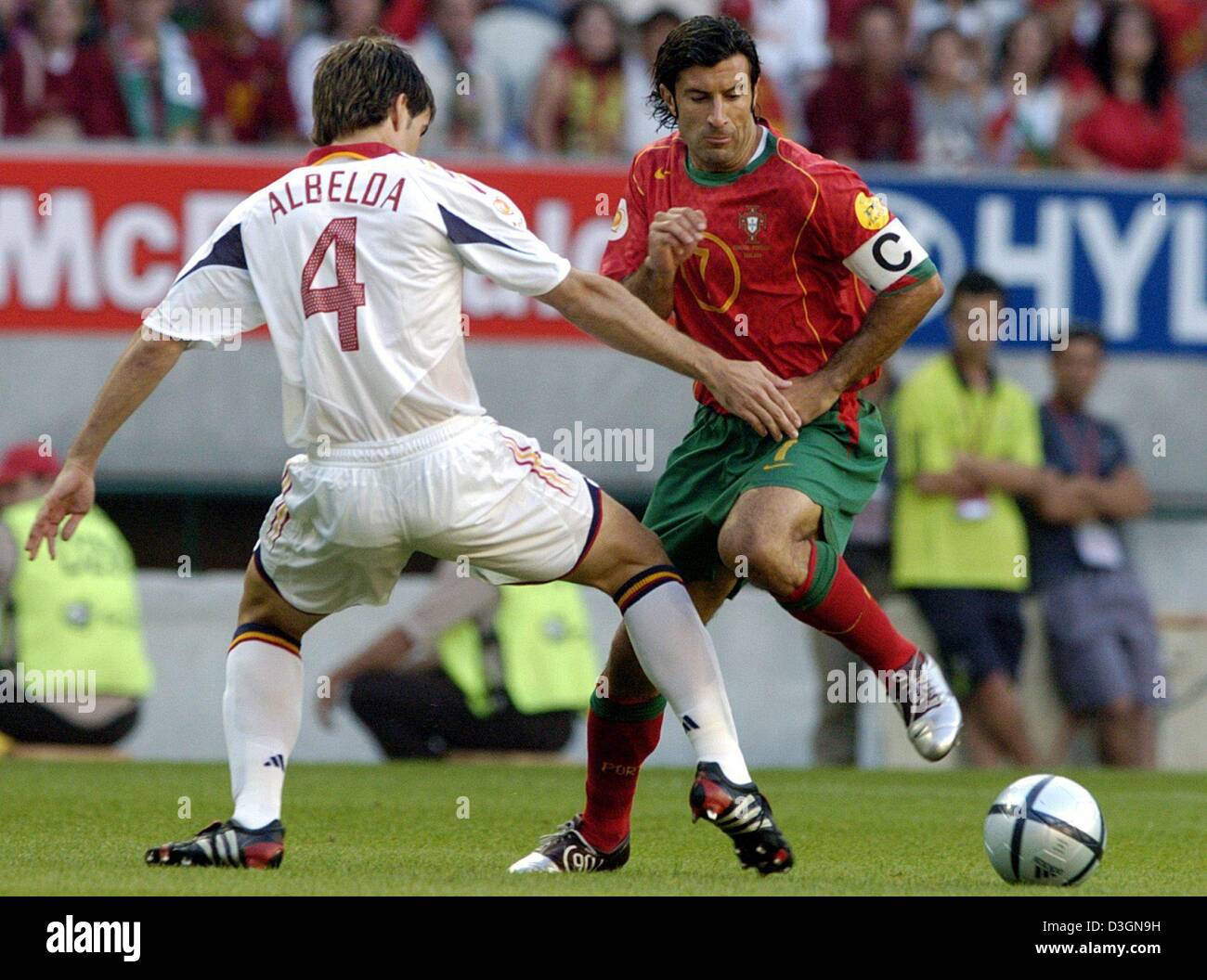 (dpa) - Portugal team captain and midfielder Luis Figo (R) fights for the ball with Spain midfielder David Albelda (L) during the Euro 2004 group A match between rivals Spain and Portugal at Jose Alvalade Stadium in Lisbon, Portugal, 20 June 2004. Portugal advanced to the quarterfinals with a 1-0 victory as Spain was eliminated. It was the first win of a Portuguese national team ov Stock Photo