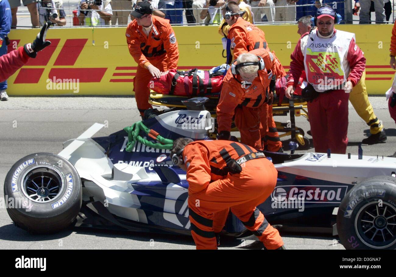 (dpa) - Paramedics and members of the safety team position German formula one pilot Ralf Schumacher of BMW-Williams on a stretcher after his accident during the US Grand Prix on the racetrack in Indianapolis, USA, 20 June 2004. Ralf Schumach ran with top speed of around 300 kilometres per hour into a barrier along the racetrack in the tenth lap of the race. Stock Photo